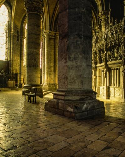 1. The image shows the interior of a Gothic cathedral featuring large clustered columns, high arched stained-glass windows, and stone flooring, with a caption identifying it as "Inside Chartres Cathedral" shot on 35mm film in 2002.
