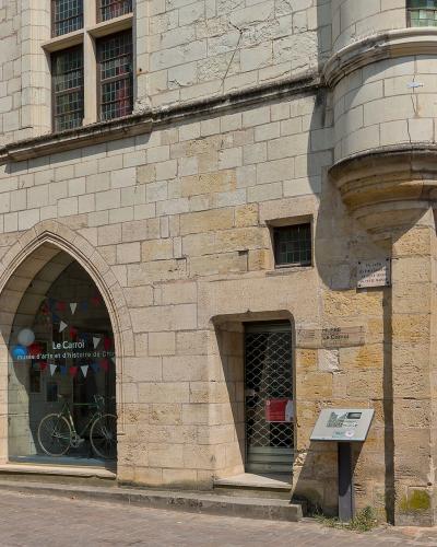 The image shows the exterior of a historic stone building with a sign reading "Musée Le Carrol" and "musée d'arts et d'histoire de Chinon," located in Chinon, France.