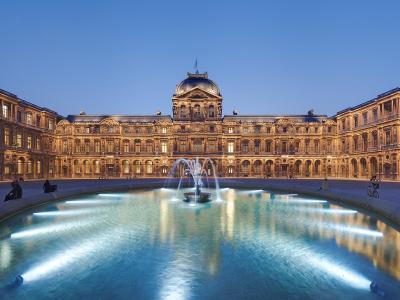 Cour Carrée of the Louvre Museum at dusk with a glowing central fountain.