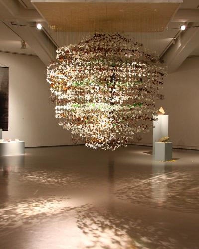 A gallery with a suspended sculpture inside MAMAC, Nice
