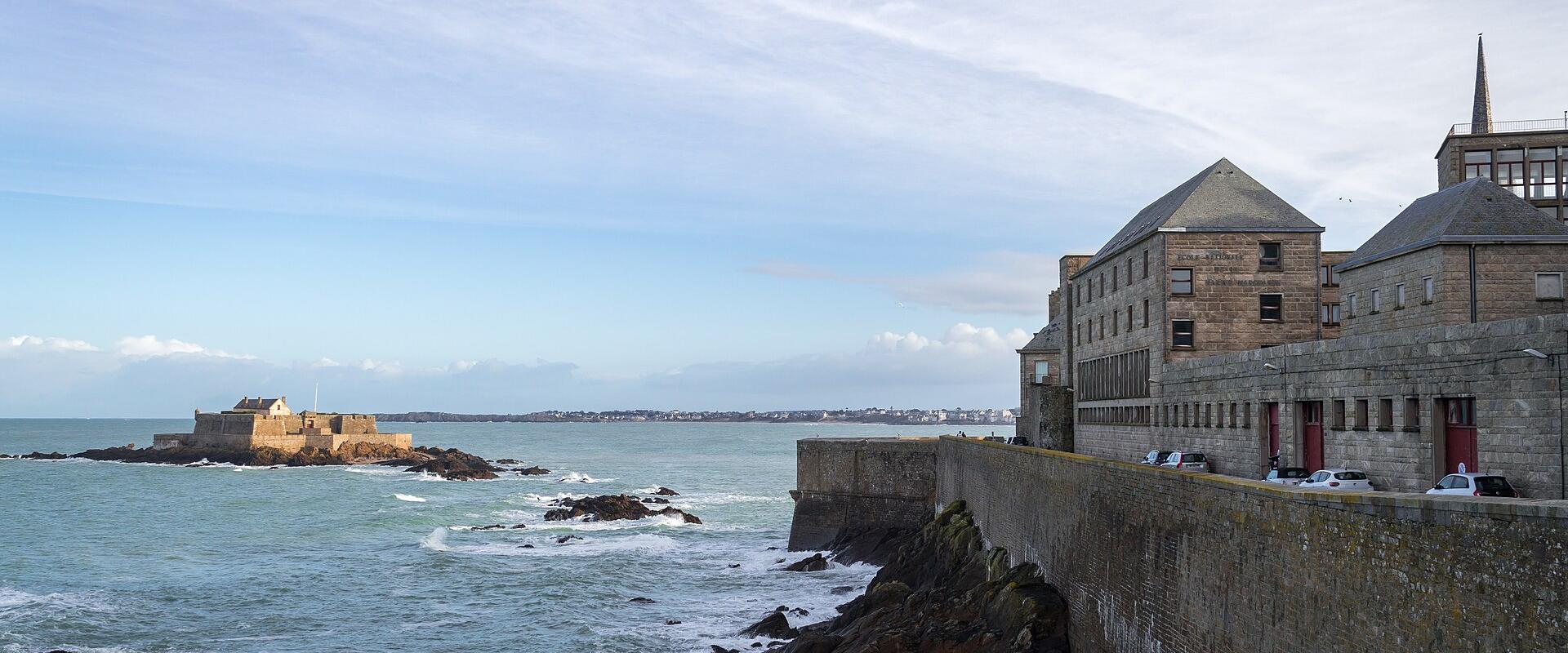 The ramparts of Saint-Malo above the sea, with Fort National offshore, Brittany