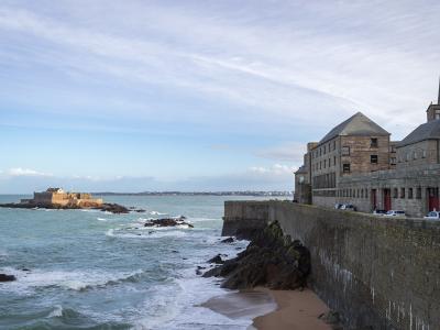 The ramparts of Saint-Malo above the sea, with Fort National offshore, Brittany