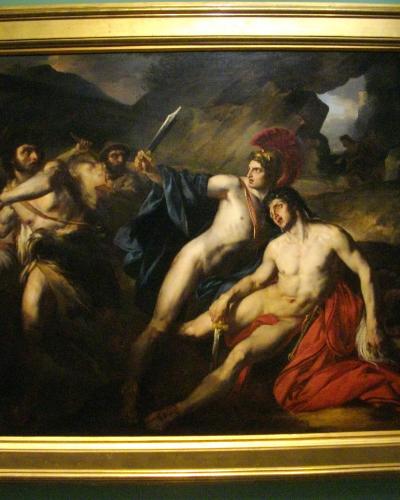 A large, framed Baroque-style painting depicting a dramatic mythological or historical scene with multiple nude and semi-nude figures in dynamic poses, mounted on a teal-colored wall inside what appears to be a museum gallery.