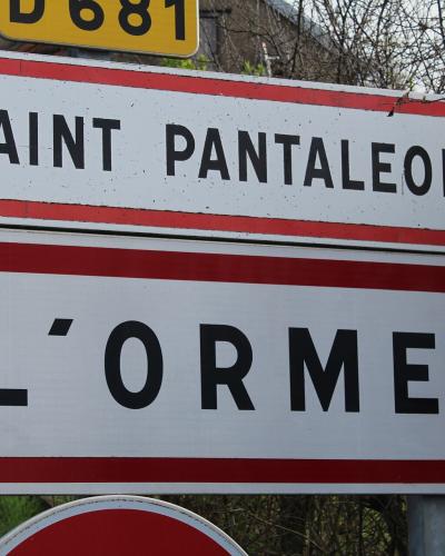 A close-up of two French municipal entry signs mounted on a post, reading "SAINT PANTALEON" and "L'ORME", with a yellow road number sign (D681) partially visible above.