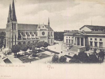 The image shows a vintage postcard view of a European town square featuring a large Gothic-style church with twin spires on the left and a neoclassical building with columns (labeled "Palais de Justice") on the right, with text at the bottom readi