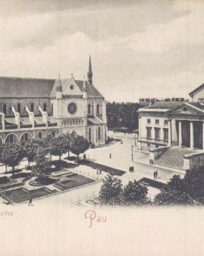 The image shows a vintage postcard view of a European town square featuring a large Gothic-style church with twin spires on the left and a neoclassical building with columns (labeled "Palais de Justice") on the right, with text at the bottom readi