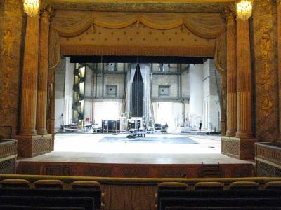 The golden-framed stage and audience seating of the Royal Opera at Versailles during a production setup.