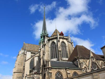 View of the Gothic spire and colorful tiled roofs of the Cathedral of Saint-Bénigne in Dijon.