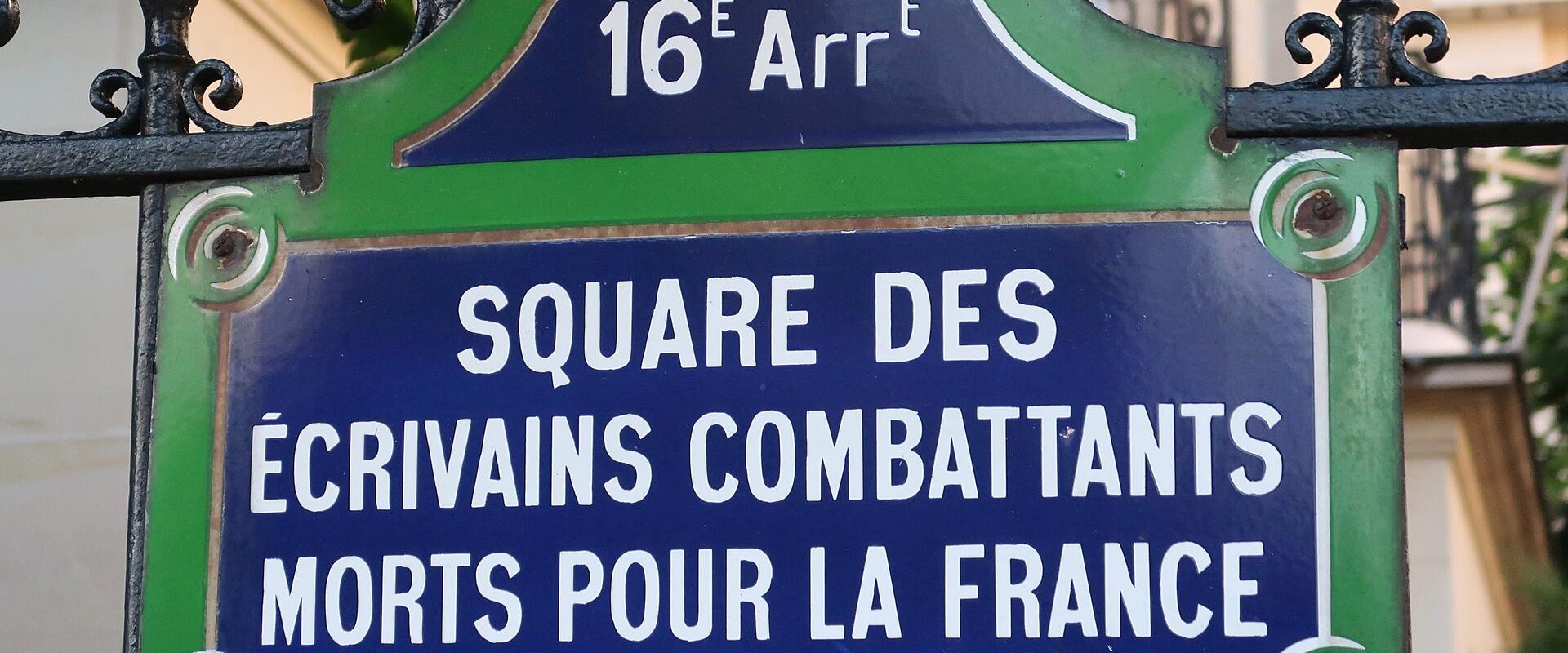 A close-up of a traditional Parisian street sign mounted on a black wrought-iron fence, displaying "16E Arrt" at the top and "SQUARE DES ÉCRIVAINS COMBATTANTS MORTS POUR LA FRANCE" in white lettering on a blue background with green borders.