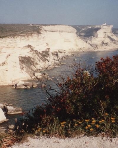 White limestone cliffs of Bonifacio, Corsica meeting the Mediterranean Sea.