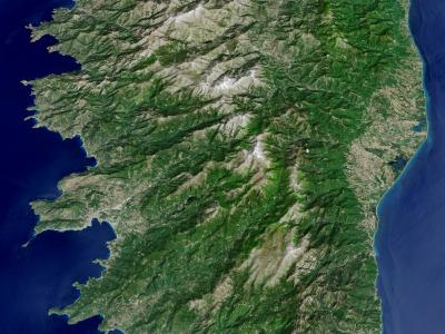 1. A satellite or aerial map view of the island of Corsica, showing its mountainous interior and surrounding Mediterranean sea.