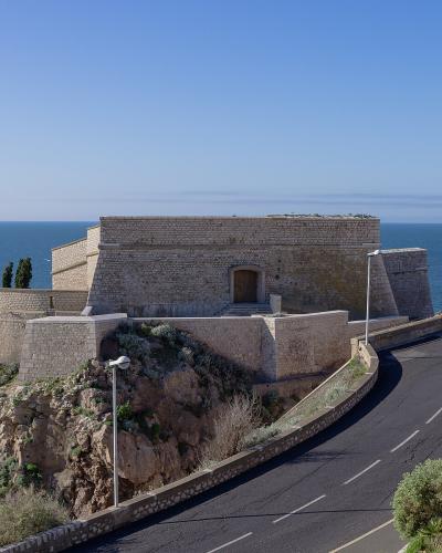 Sète's historic Fort Saint-Pierre jutting into the blue sea under a clear sky.