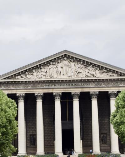 Neoclassical Greek-temple facade of La Madeleine church (Eglise Sainte-Marie-Madeleine), Paris.