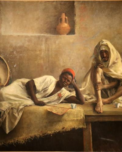 Orientalist painting of three men in a dim room, one reclining and two seated.