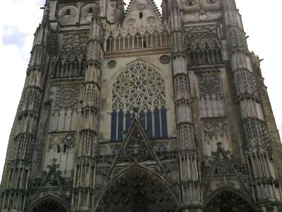 An architectural restoration drawing showing detailed Gothic tracery, pinnacles, and rose windows of a cathedral facade, with text reading "CATHÉDRALE DE TOURS - RESTAURATION."