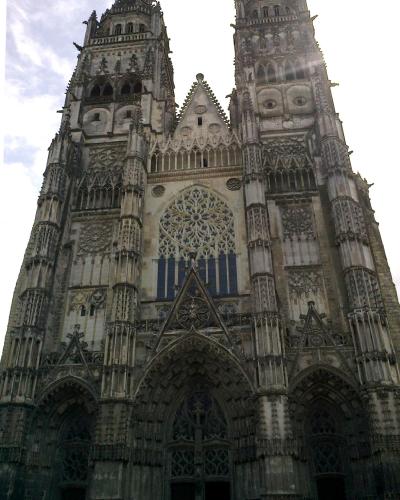 An architectural restoration drawing showing detailed Gothic tracery, pinnacles, and rose windows of a cathedral facade, with text reading "CATHÉDRALE DE TOURS - RESTAURATION."