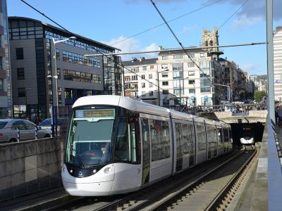 A white Alstom Citadis 302 tram (number 854) on tracks in an urban setting, with a station platform visible on the right and buildings in the background; the destination display on the tram reads "THÉÂTRE DES ARTS".